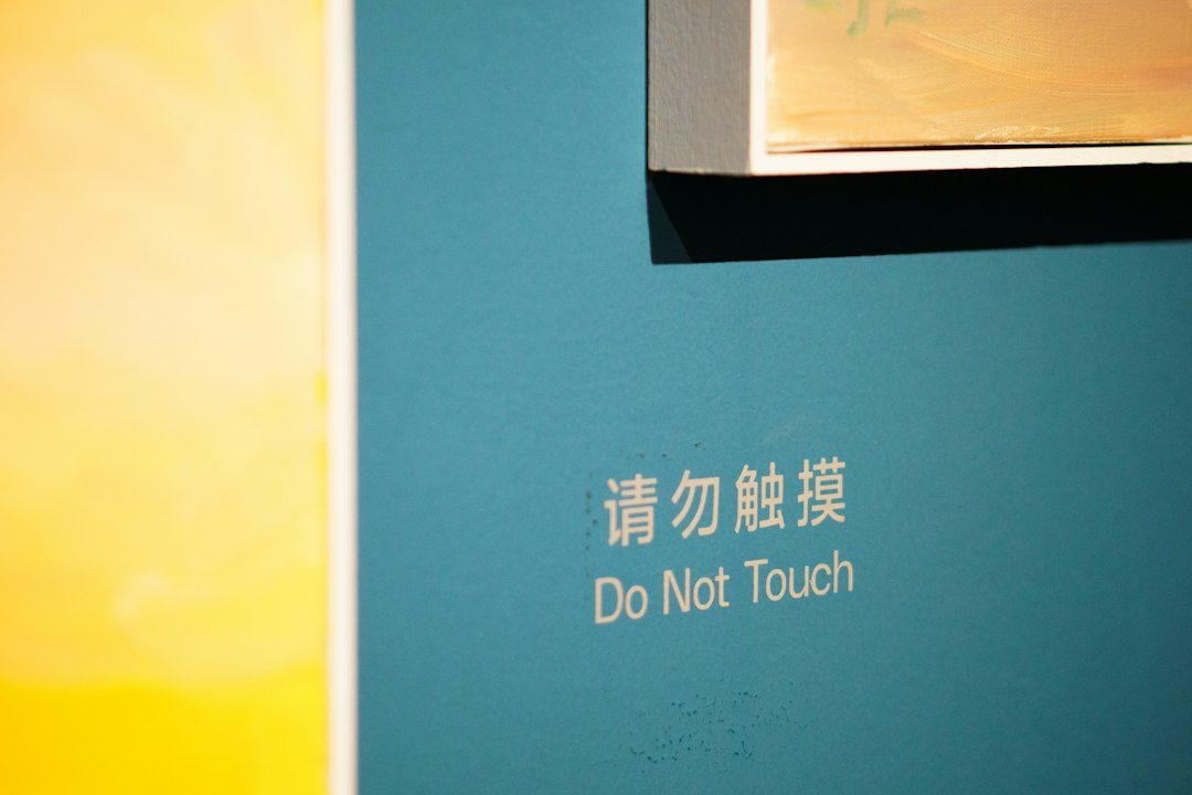 a blue wall with a do not touch sign on it