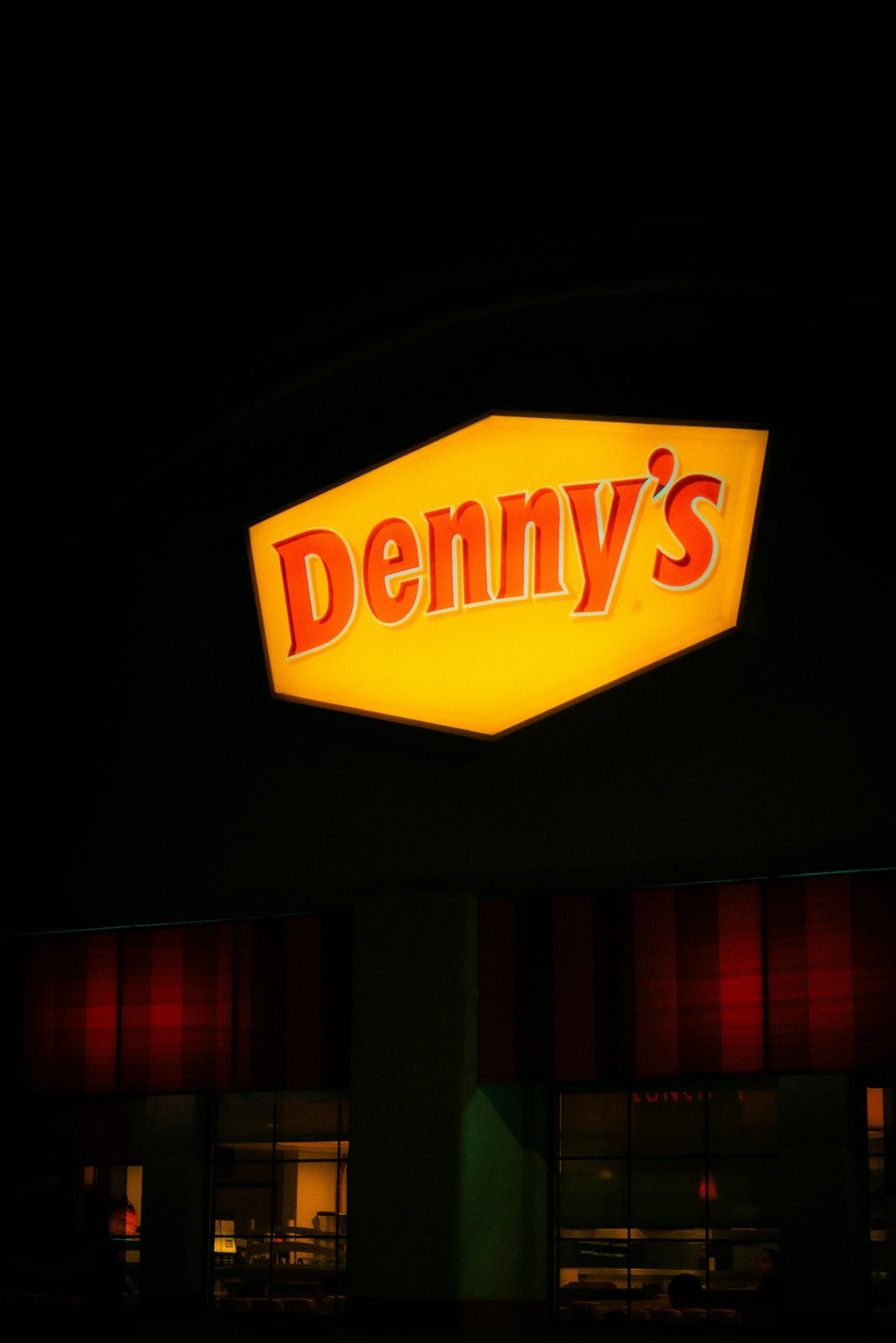 Denny's restaurant sign illuminated at night